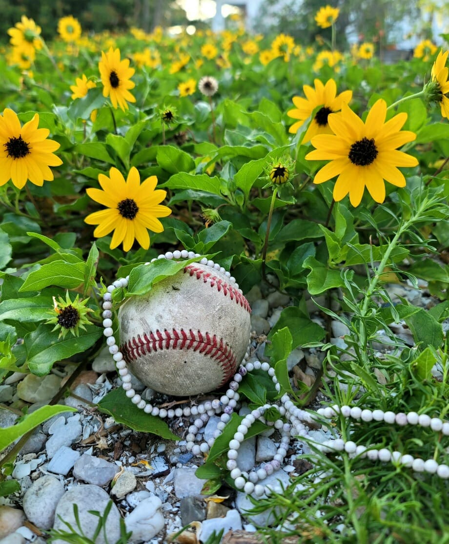 baseball and pearls in flowers