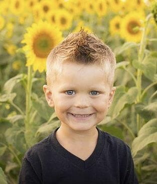 boy in sunflower field